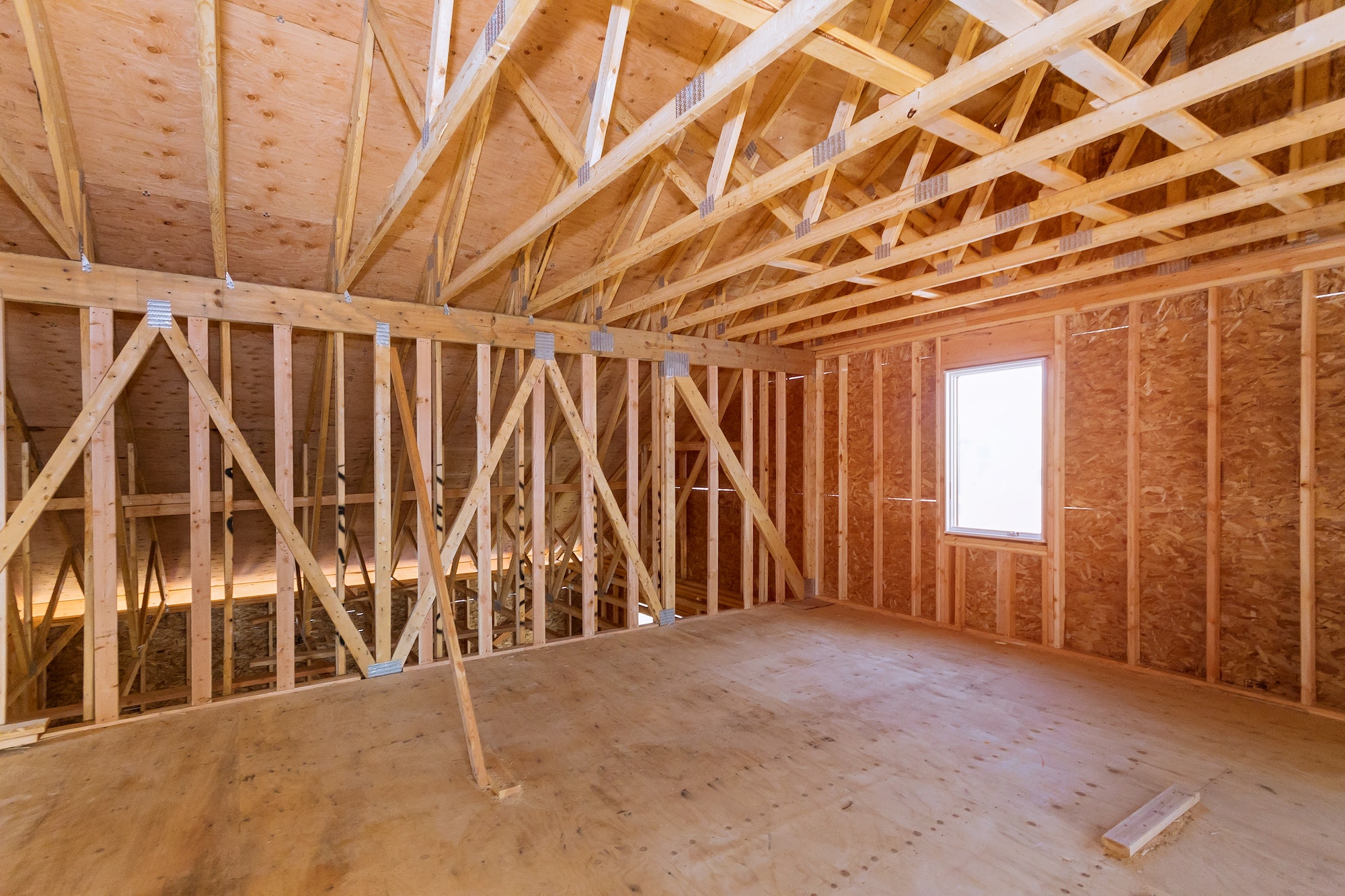 Unfinished attic of a private house residential construction house framing agains